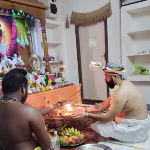 Priests performing Agasthiyar Nadi homa fire ritual with offerings in Madurai.